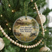 A round ornament hanging on a Christmas tree, featuring an illustration of Fort Hartsuff State Historical Park in Nebraska.