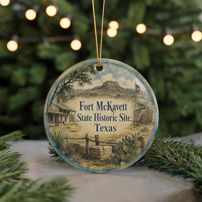 A round ornament with a picture of Fort McKavet, a historic site in Texas, hanging from a string.