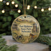 A round ornament with a picture of Fort Robinson State Park in Nebraska, featuring a horse and a cannon, is displayed on a Christmas tree branch with twinkling lights in the background.
