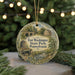 A round ornament with a painting of Fort Washington State Park, Pennsylvania, featuring a bridge, a house, and a cannon, surrounded by greenery and twinkling lights.