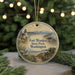 A round ornament with a lighthouse and a coastal scene, featuring the text "Fort WORDEN State Park, Washington".