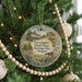 A round ornament hanging on a Christmas tree, featuring a scenic image of the Frenchglen Hotel and Heritage Site in Oregon.