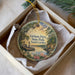 A decorative ornament in a box, featuring a scenic landscape with a river, trees, and a boat, along with the text "Givhan's Ferry State Park, South Carolina".