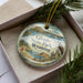 A decorative ornament with a scenic landscape of Glendo State Park, Wyoming, featuring a bird, a lake, and mountains.
