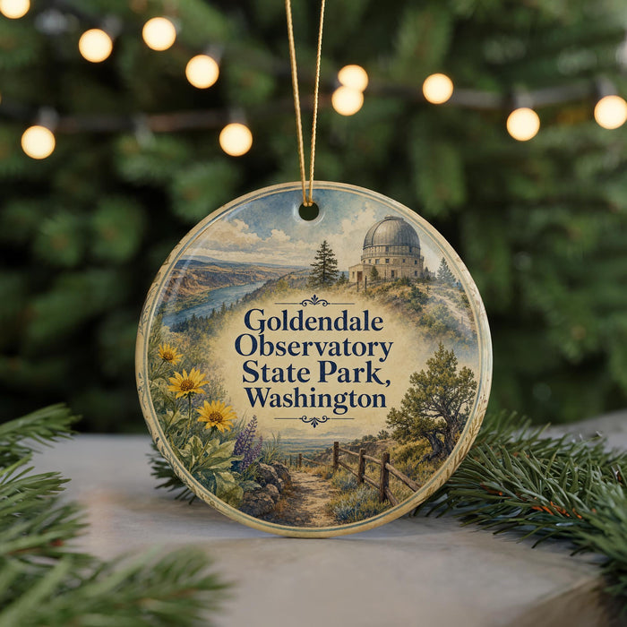 A round ornament with a scenic landscape featuring a dome-shaped building, trees, and a path, hanging from a string.