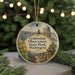 A round ornament with a scenic landscape featuring a dome-shaped building, trees, and a path, hanging from a string.