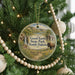 A Christmas tree ornament featuring a scenic image of Good Earth State Park, South Dakota, with a bison in the foreground and a waterfall in the background.
