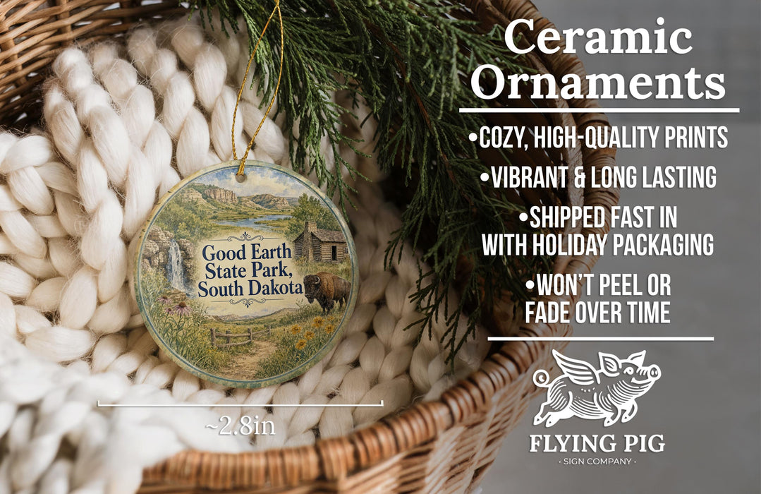 Ceramic ornaments, including a round ornament with a scenic image of Good Earth State Park, South Dakota, hanging from a wicker basket.
