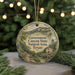 A round ornament with a scenic illustration of the Government Canyon State Natural Area in Texas, surrounded by greenery and a string of lights.