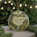A circular ornament featuring a scenic landscape of Governor Dodge State Park, Wisconsin, with a waterfall and pine trees.