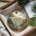 A decorative ornament with a scenic image of the Governor Earl Peshtigo River State Forest in Wisconsin, featuring pine trees, a river, and a boat.