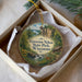 A circular ornament with a scenic landscape of a river, forest, and a cabin, featuring the text "Governor Nelson State Park, Wisconsin".