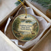 A decorative ornament in a box, featuring a scenic landscape with a bench, trees, and a deer, along with the text "Grahams Island State Park, North Dakota".