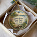 A decorative ornament in a box, featuring a scenic image of Grass Point State Park in New York.