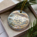A decorative ornament in a box, featuring a scenic image of the Great Salt Lake State Park in Utah.