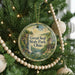 A round ornament hanging on a Christmas tree, featuring a scenic image of a waterfall and a house, with the text "Great Seal State Park, Ohio" displayed on it.