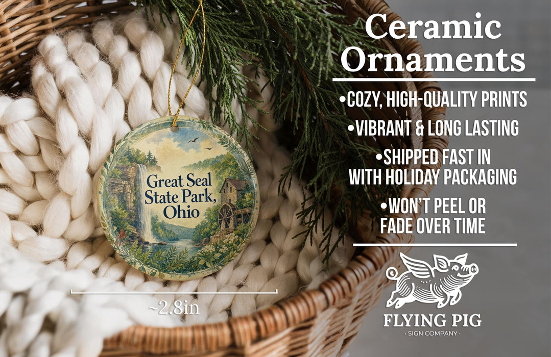 Ceramic ornaments, including a Great Seal State Park ornament, are displayed in a basket with pine branches.
