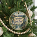 A round ornament hanging on a Christmas tree, featuring a scenic image of the Green River Gorge State Park in Washington.