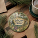 A round ornament with a scenic illustration of Ha Tonka State Park, Missouri, hanging on a wooden surface.