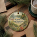 A decorative ornament with a scenic image of Half Moon Pond State Park, Vermont, hanging on a wooden surface.