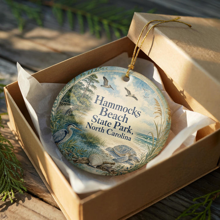 A decorative ornament in a wooden box, featuring a beach scene with birds and a turtle, along with the text "Hammonds Beach State Park, North Carolina".