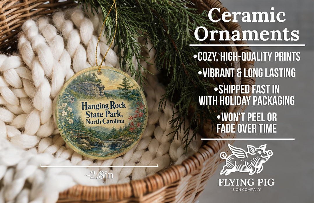 Ceramic ornaments hanging from a tree branch, with a basket of white yarn nearby.