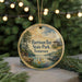 A circular ornament featuring a scenic landscape with a lake, dock, and trees, along with the text "Harison Bay State Park, Tennessee".