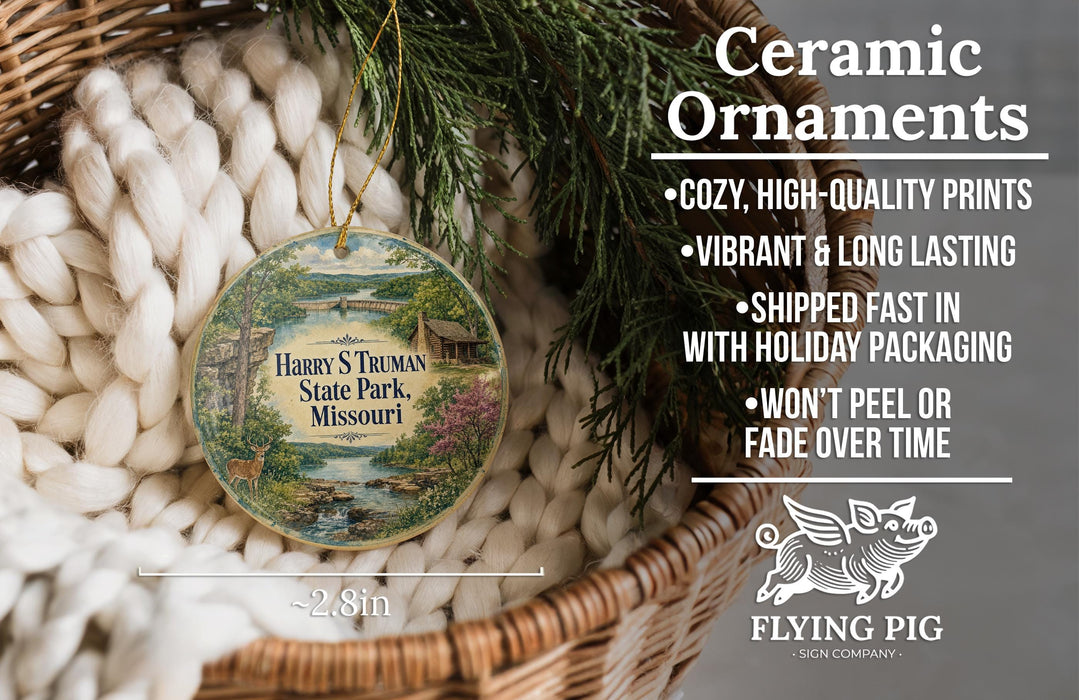 Ceramic ornaments, featuring a detailed illustration of a scenic landscape with a river and a cabin, are displayed in a woven basket.