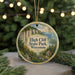 A circular ornament featuring a scenic landscape with a cliff, trees, and a body of water, with the text "High Cliff State Park, Wisconsin" prominently displayed.