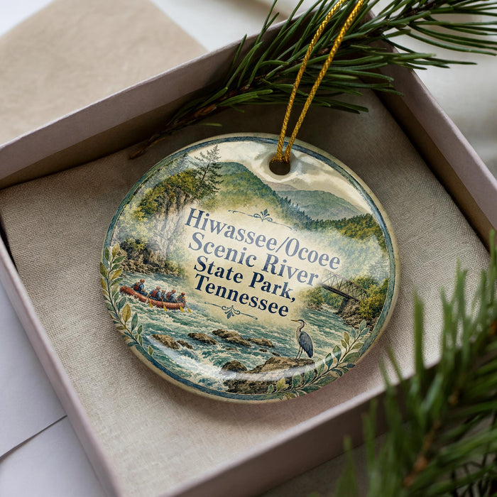A decorative ornament with a scenic river and mountains in the background, featuring a boat and people enjoying the river.