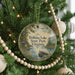 A round ornament hanging on a Christmas tree, featuring a scenic image of Holliday Lake State Park, Virginia.