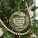 A round ornament hanging on a Christmas tree, featuring a scenic landscape of Hope Island, Washington.