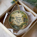 A decorative ornament in a box, featuring a scenic image of Hueston Woods State Park, Ohio.