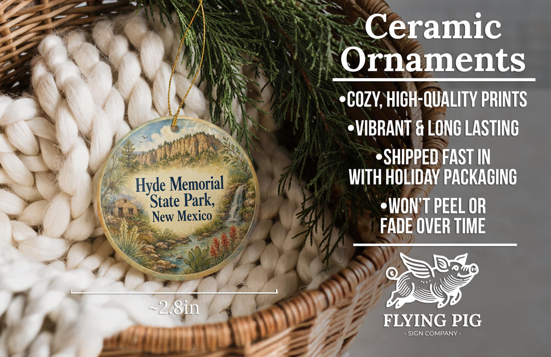 Ceramic ornaments, specifically those featuring the Hyde Memorial State Park in New Mexico, are displayed in a woven basket. The text highlights the ornaments as "cozy, high-quality prints" and "vibrant and long lasting", with a description of their shipping speed and packaging. The image also includes a logo for "Flying Pig - SIGN COMPANY".