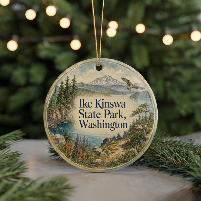 A circular ornament with a scenic landscape of mountains, pine trees, and a lake, featuring the text "Ike Kinswa State Park, Washington".