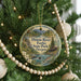 A round ornament hanging on a Christmas tree, featuring a scenic image of Illinois River Forks State Park, Oregon.