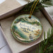 A decorative ornament in a box, featuring a scenic image of Jackson Lake State Park, Ohio.