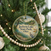 A round ornament hanging on a Christmas tree, featuring a scenic image of Jackson Lake State Park, Ohio.