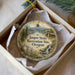 A decorative ornament in a box, featuring a scenic landscape with mountains, pine trees, and a waterfall. The text on the ornament reads "Jasper State Recreation Site, Oregon".