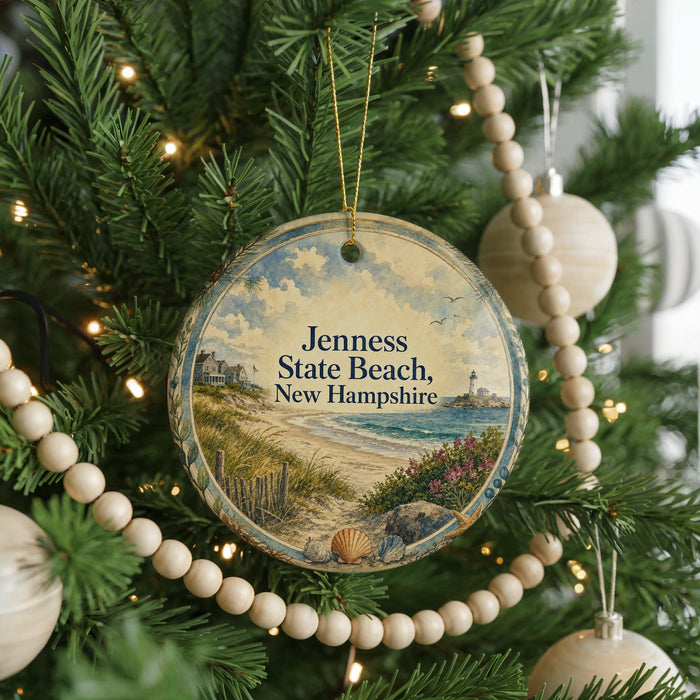 A round ornament hanging on a Christmas tree, featuring a scenic image of a beach and lighthouse.
