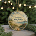 A round ornament with a beach scene and lighthouse, featuring the text "Jenessy State Beach, New Hampshire" on it.