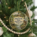 A round ornament hanging on a Christmas tree, featuring a scenic image of Johnsonville State Historic Park in Tennessee.