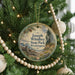 A round ornament hanging on a Christmas tree, featuring a scenic image of Joseph Whidbey State Park in Washington.