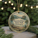 A circular ornament with a scenic landscape of Kanaskat-Palmer State Park, Washington, featuring a lake, mountains, pine trees, and a pine tree trunk.