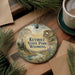 A decorative ornament with the text "Keyhole State Park, Wyoming" on it, surrounded by pine branches and a cup of coffee on a wooden surface.