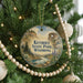 A round ornament on a Christmas tree, featuring a scenic landscape with mountains and a lake, with the text "Keyhole State Park, Wyoming" displayed prominently.