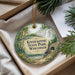 A decorative ornament with a scenic image of the Kinnickin State Park in Wisconsin, featuring a waterfall, pine trees, and a stone bridge.