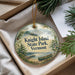 A decorative ornament with a scenic landscape of Knight Island, Vermont, featuring pine trees, a canoe, and mountains.