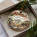 A decorative ornament in a box, featuring an illustration of the Kodachrome Basin State Park in Utah.