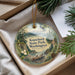 A decorative ornament with a scenic landscape of Kopachuck State Park, Washington, featuring pine trees, a river, and mountains.